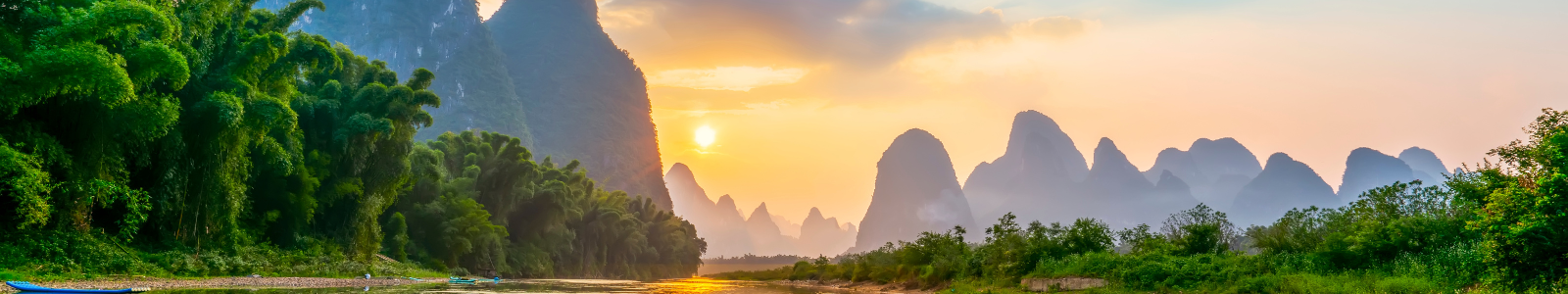 Scenic view of mountains and river at sunset